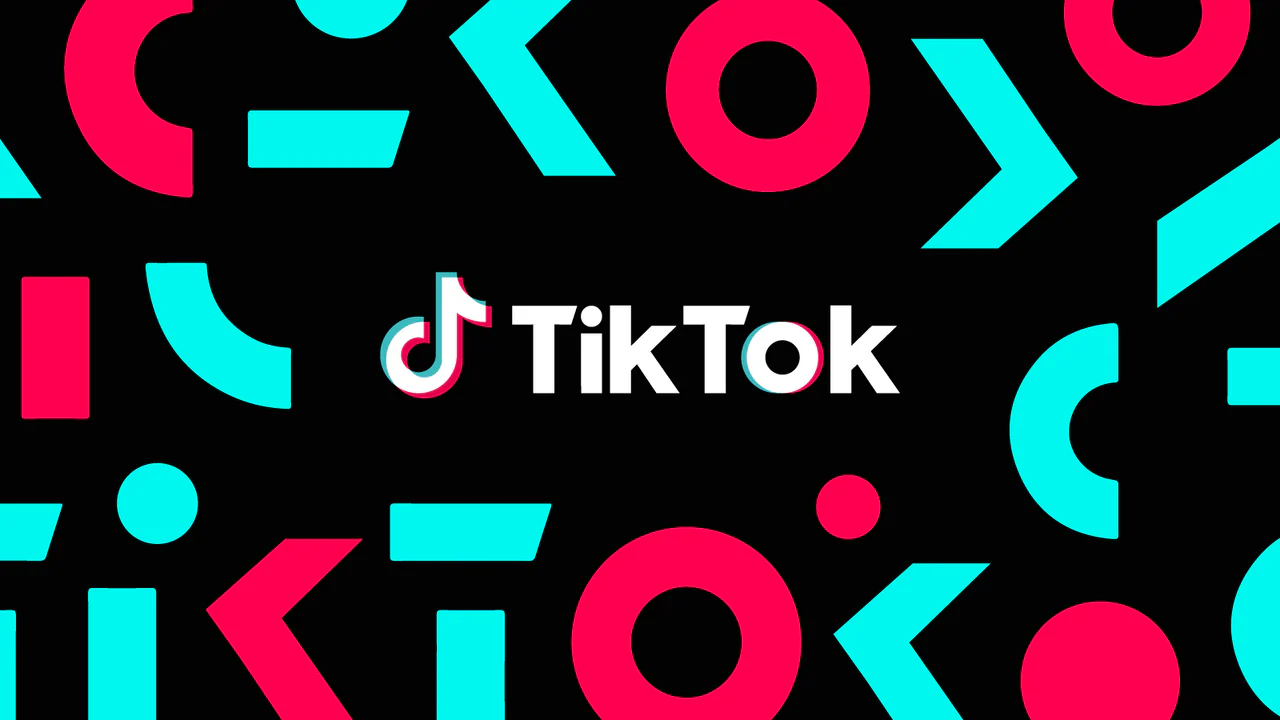 Logotipo do TikTok em um fundo preto, com letras coloridas vibrantes, representando a popularidade das redes sociais.